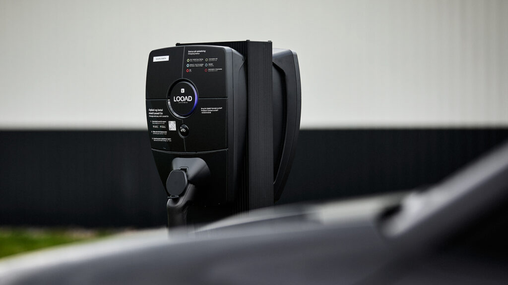 a close up of a black electric vehicle charging station