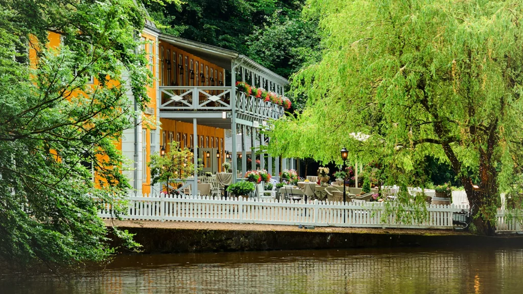 a building with a white fence and trees